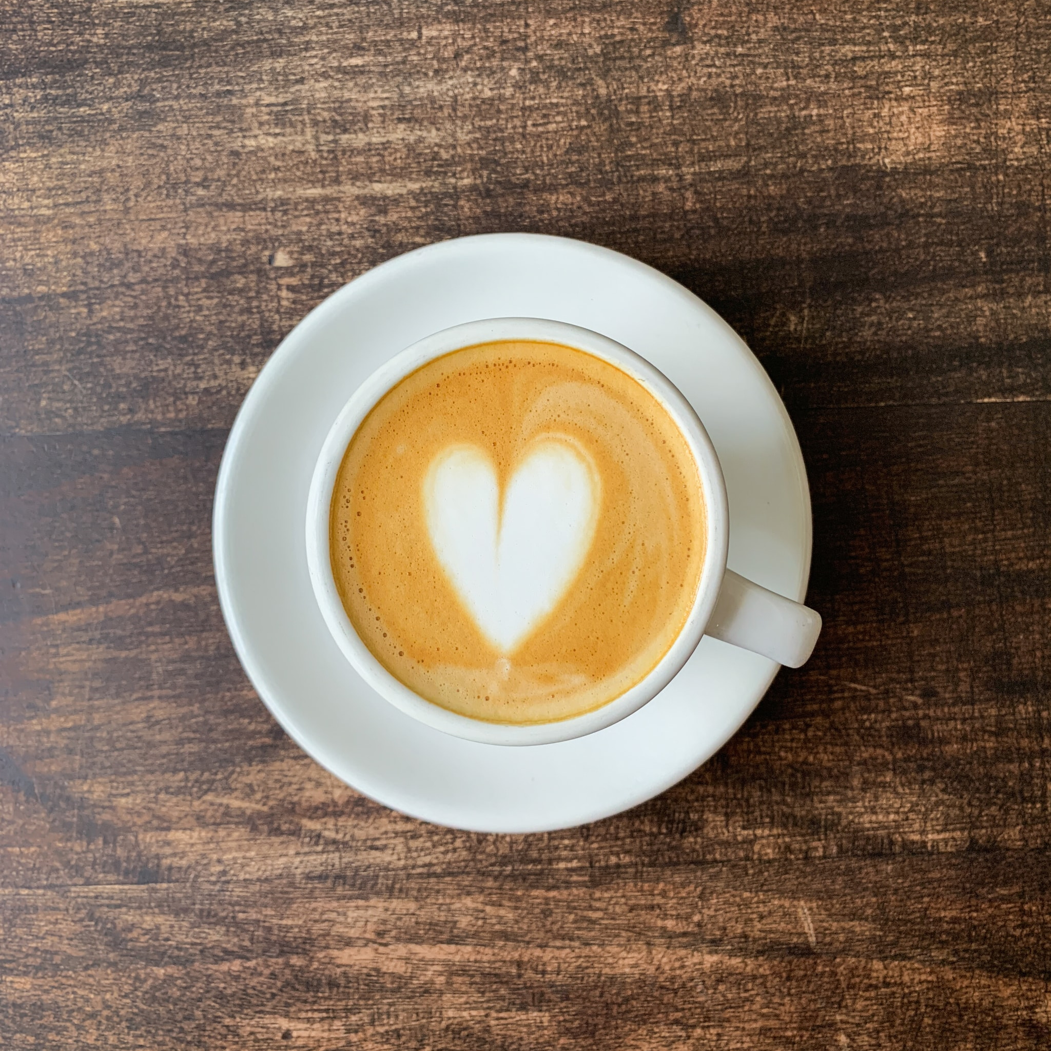 The image of a cup of coffee with a heart drawn on it