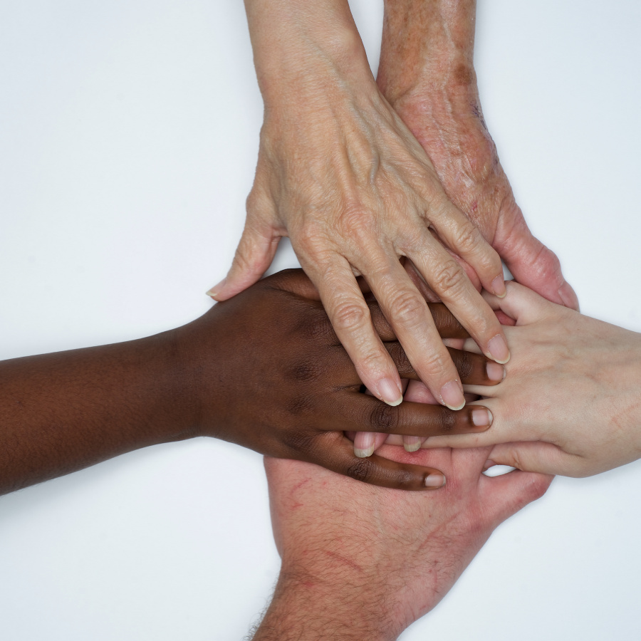 diverse hands resting on top of each other