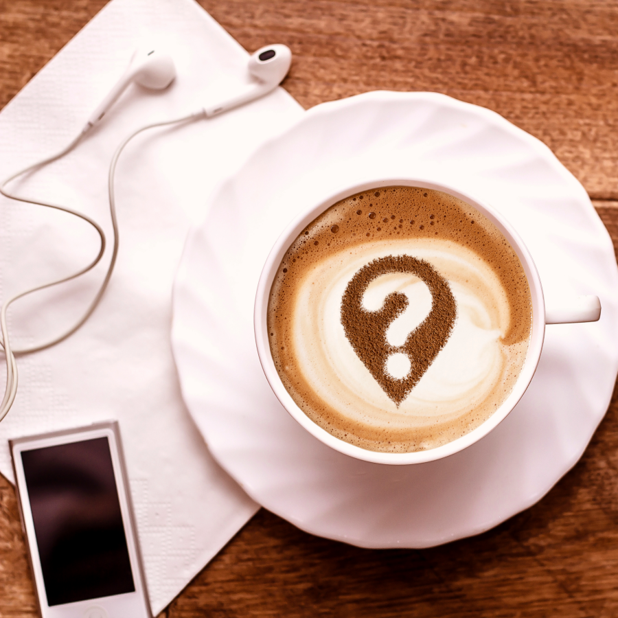 the image of a cup of coffee with a question mark in the foam next to an iPod and headphones